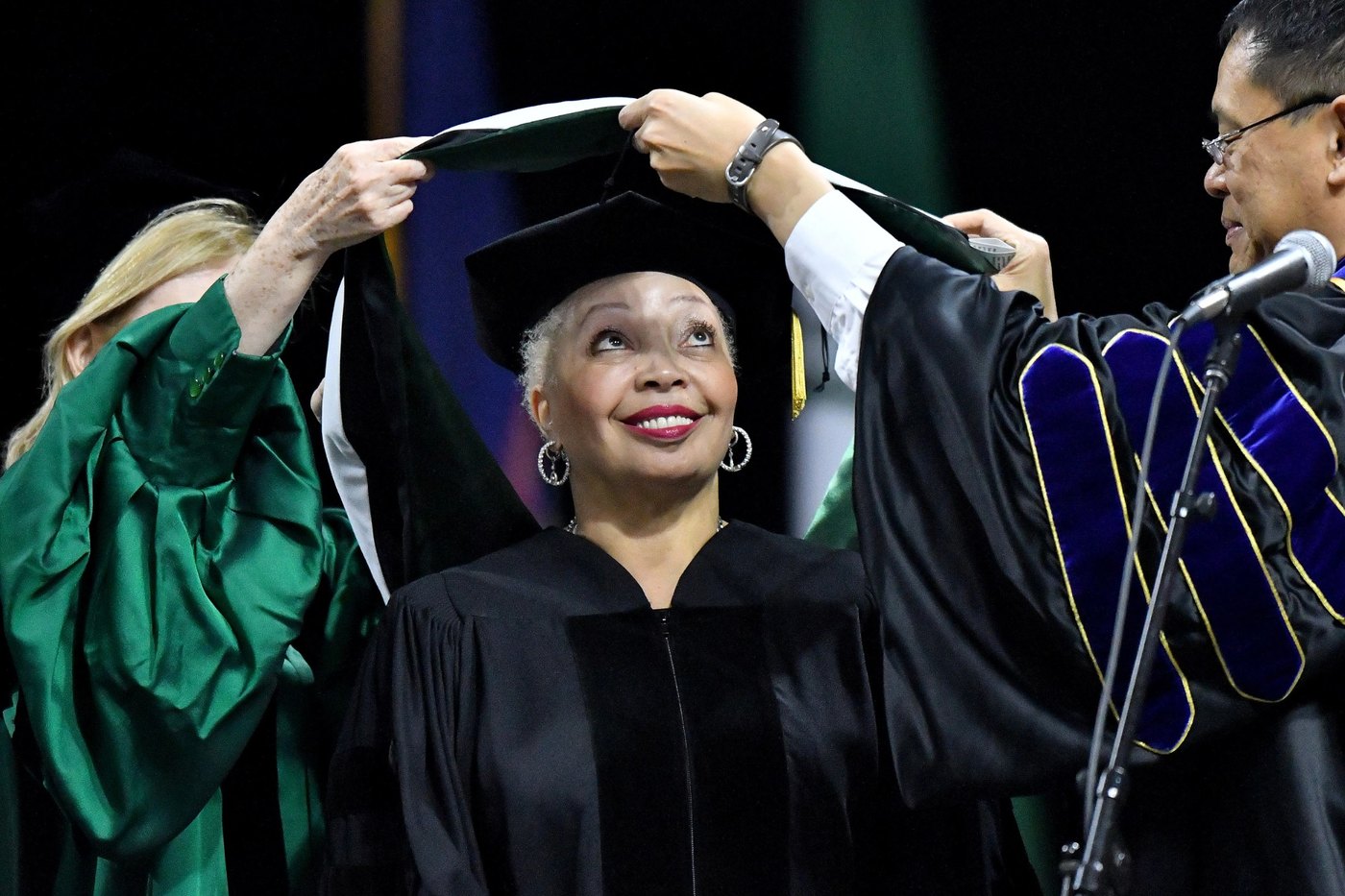 Wanda J. Herndon receives her honorary Doctor of Humanities hood at MSU's 2018 commencement, Breslin Center
