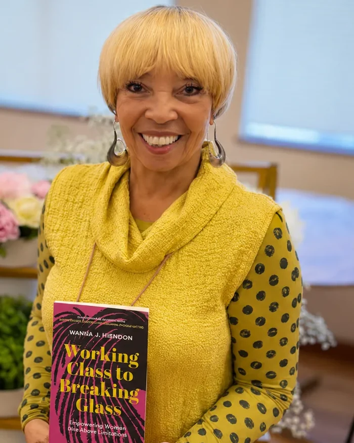 Wanda J. Herndon holding her memoir Working Class to Breaking Glass at the book launch